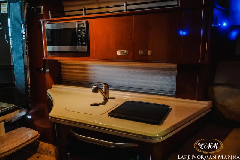 Slide: The Image of Interior of 2011 Sea Ray 280 Sundancer with kitchenette, microwave, and sink. - 16