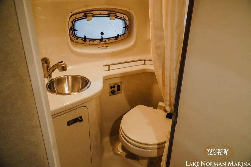 Slide: The Image of Compact bathroom in 2011 Sea Ray 280 Sundancer boat with sink and toilet. - 19