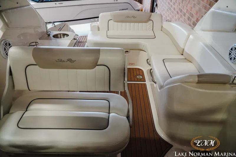 Slide: The Image of Interior of 2011 Sea Ray 280 Sundancer with plush seating and wood accents at Lake Norman Marina. - 21