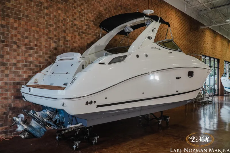 Slide: The Image of 2011 Sea Ray 280 Sundancer boat displayed indoors at Lake Norman Marina. - 3