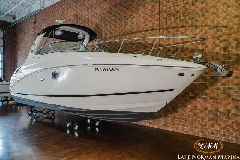 Slide: The Image of 2011 Sea Ray 280 Sundancer boat displayed indoors at Lake Norman Marina. - 4