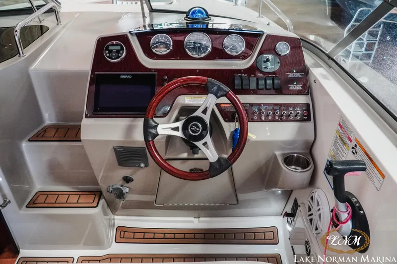 Slide: The Image of 2011 Sea Ray 280 Sundancer helm with wood accents and modern controls at Lake Norman Marina. - 9