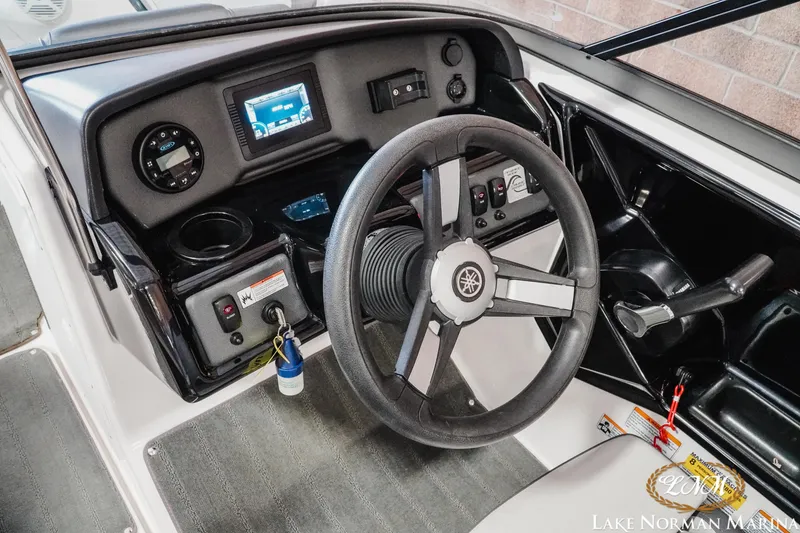 Slide: The Image of 2022 Yamaha Boats AR 190 dashboard with steering wheel and control panel. - 11