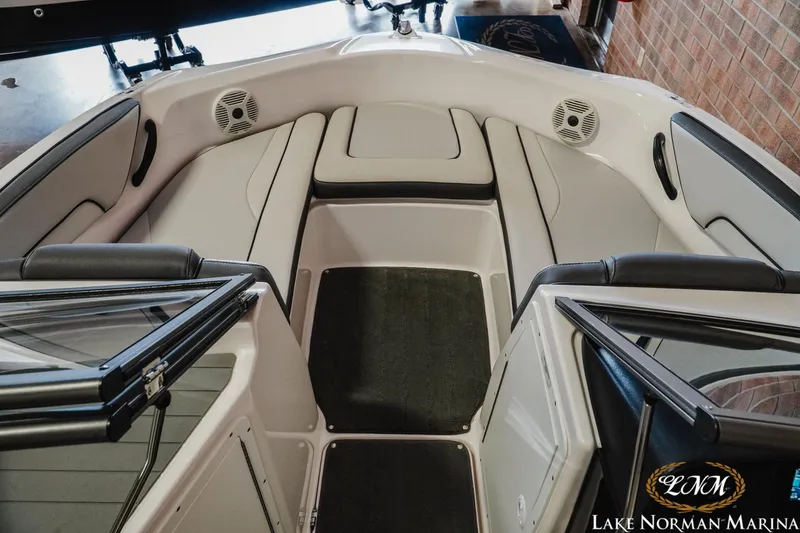 Slide: The Image of 2022 Yamaha Boats AR 190 interior with cushioned seating and speakers at Lake Norman Marina. - 12