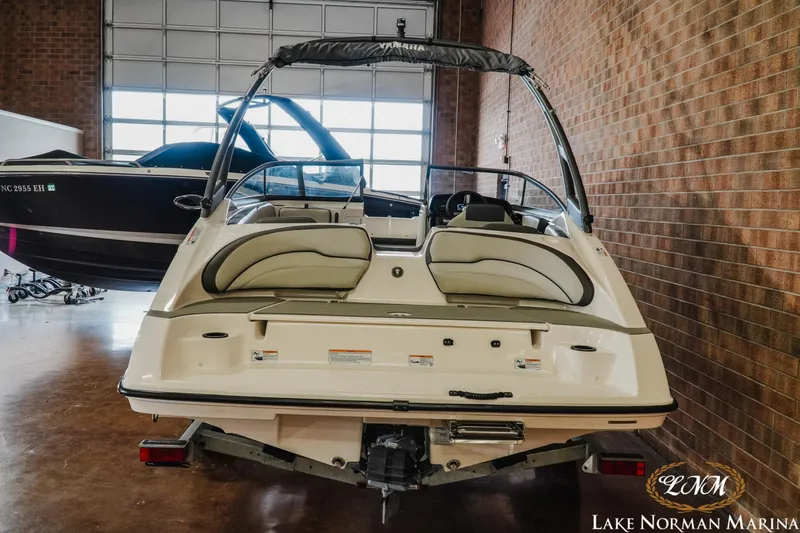 Slide: The Image of 2022 Yamaha Boats AR 190 in a marina showroom, rear view. - 6