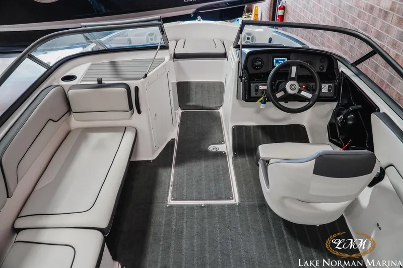 Slide: The Image of 2022 Yamaha Boats AR 190 interior with sleek seating and modern dashboard at Lake Norman Marina. - 8