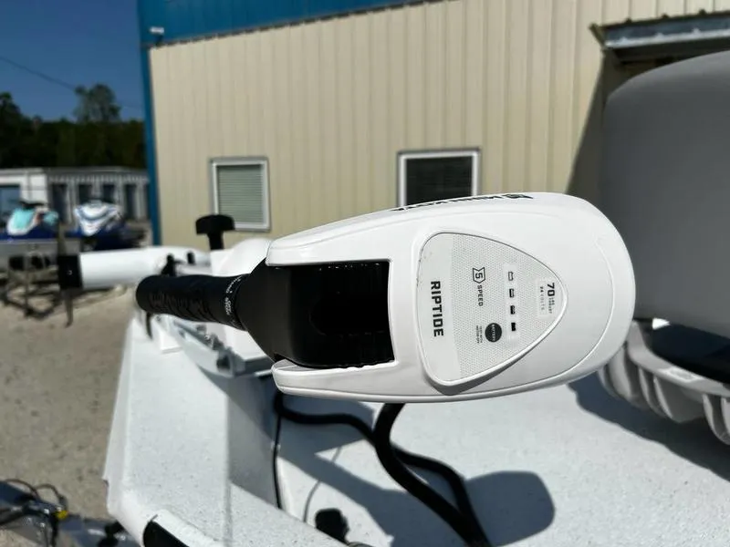 Slide: The Image of 2025 Xpress H22B boat with Riptide trolling motor, outdoor setting. - 11