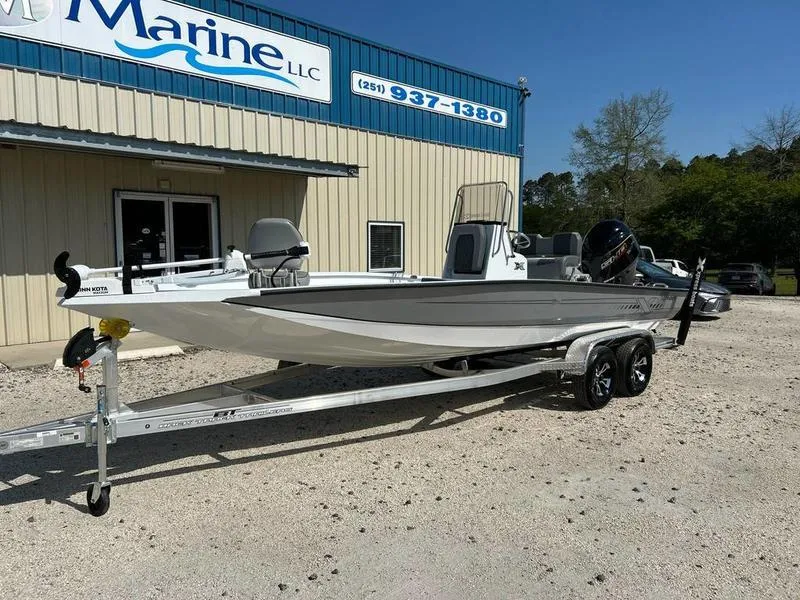 Slide: The Image of 2025 Xpress H22B boat on trailer outside marine dealership. - 12