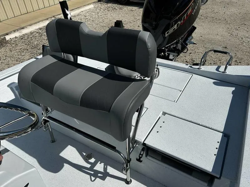 Slide: The Image of 2025 Xpress H22B boat interior with dual-tone seating and storage compartments. - 8