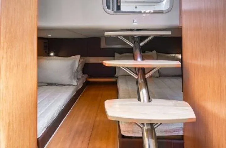 Slide: The Image of 2018 Chris-Craft Launch interior cabin with wooden steps and cozy sleeping area. - 11