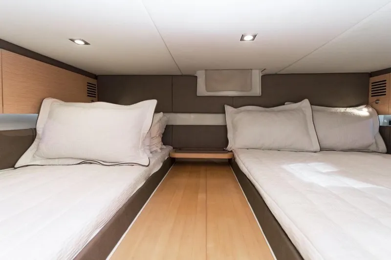 Slide: The Image of 2018 Chris-Craft Launch cabin interior with twin beds and modern lighting. - 12