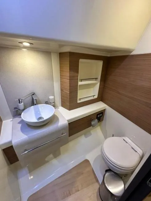 Slide: The Image of 2018 Chris-Craft Launch bathroom with modern sink, toilet, and wood accents. - 13