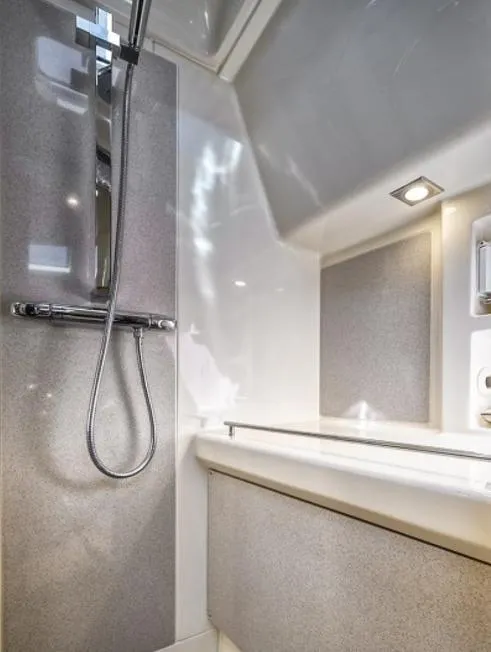 Slide: The Image of 2018 Chris-Craft Launch boat interior shower with modern fixtures and sleek design. - 14