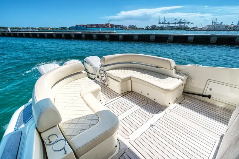 Slide: The Image of 2018 Chris-Craft Launch boat with luxurious seating, docked by clear blue water. - 3