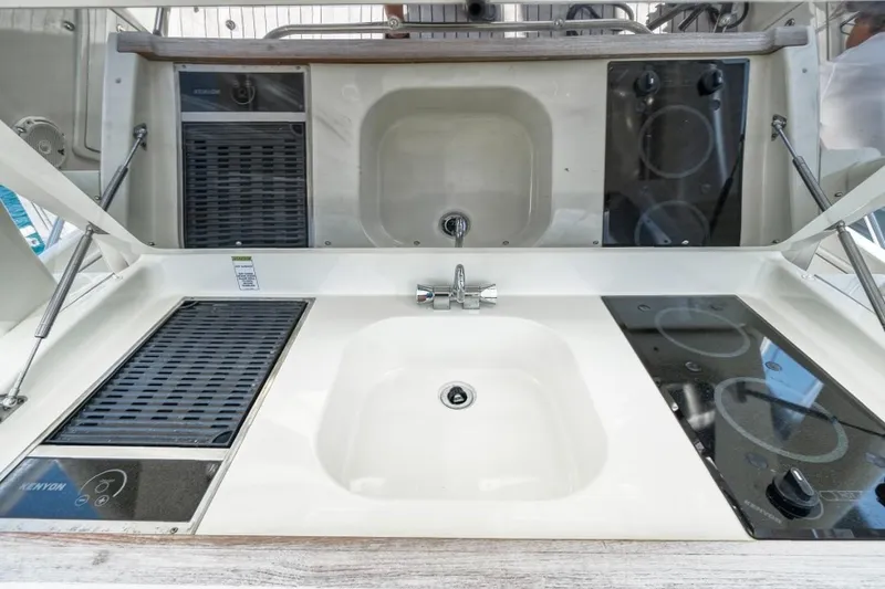 Slide: The Image of 2018 Chris-Craft Launch boat kitchen with sink, stove, and grill setup. - 5