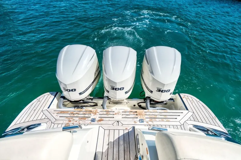 Slide: The Image of 2018 Chris-Craft Launch boat with triple 300 horsepower engines on turquoise water. - 9