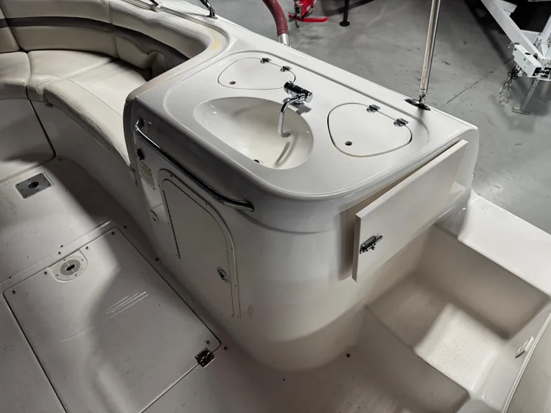 Slide: The Image of 2005 Chaparral Sunesta 232 boat interior with sink and seating area. - 11