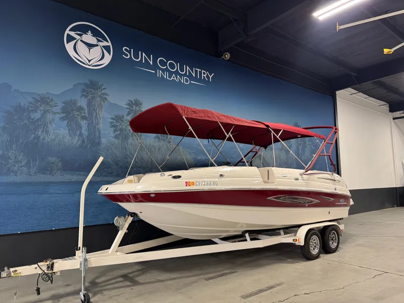 Slide: The Image of 2005 Chaparral Sunesta 232 boat with red canopy on trailer at Sun Country Inland showroom. - 2