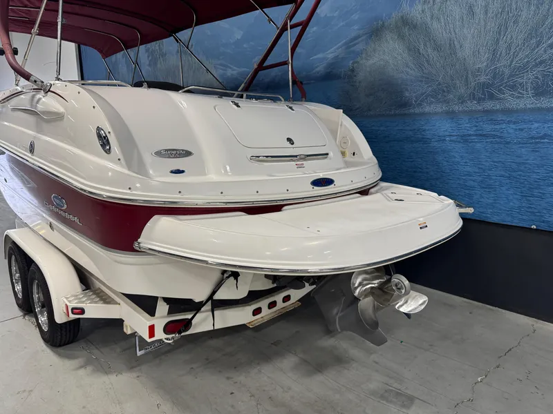 Slide: The Image of 2005 Chaparral Sunesta 232 boat with red and white exterior on a trailer. - 4