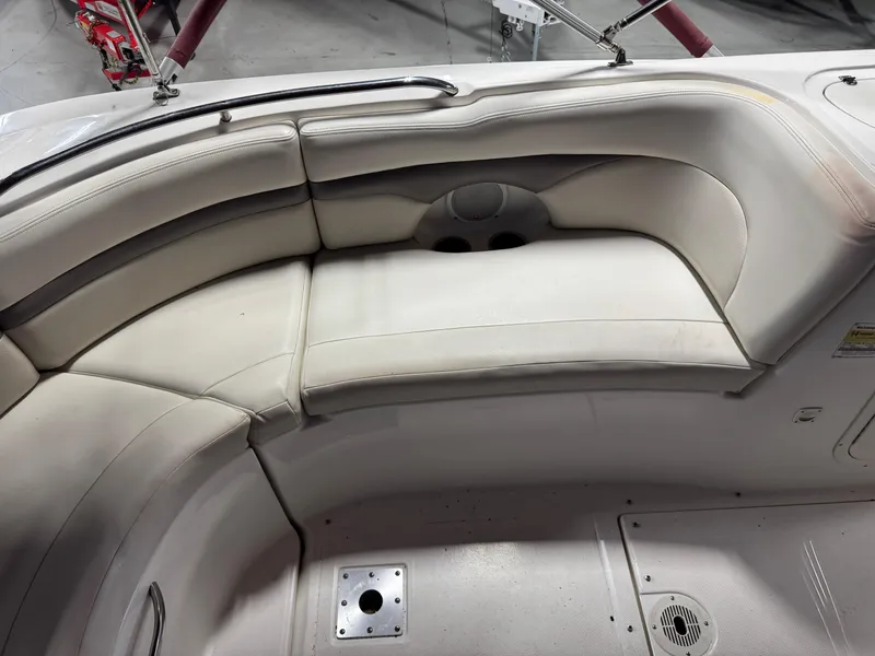 Slide: The Image of 2005 Chaparral Sunesta 232 boat interior with beige seating and cup holders. - 8