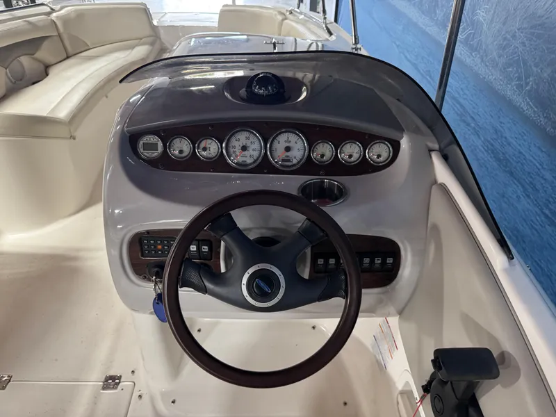 Slide: The Image of 2005 Chaparral Sunesta 232 boat dashboard with steering wheel and instrument panel. - 9