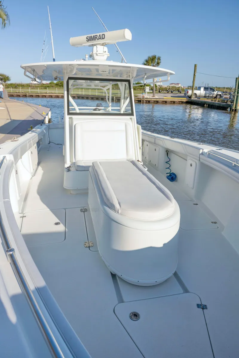 Slide: The Image of 2019 Yellowfin 39 Offshore boat docked, featuring spacious deck and advanced navigation equipment. - 12