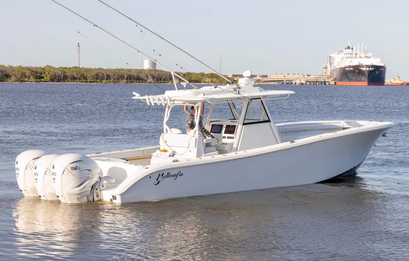 Slide: The Image of 2019 Yellowfin 39 Offshore boat with triple outboard engines on calm water. - 4
