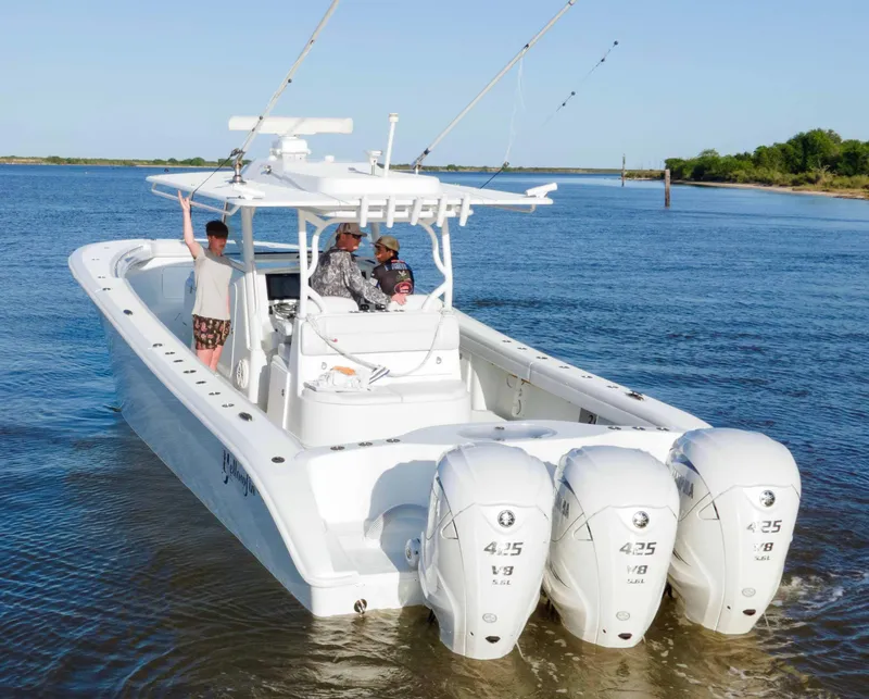 Slide: The Image of 2019 Yellowfin 39 Offshore boat with triple engines on a calm waterway. - 8