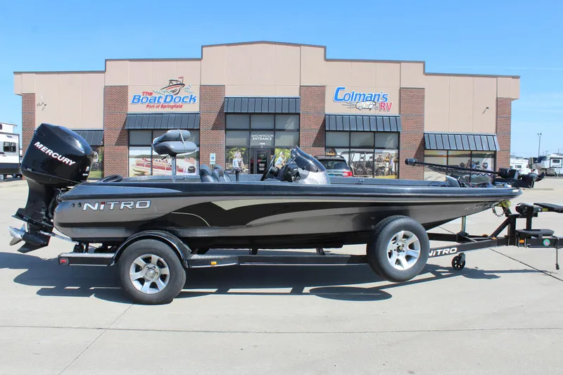 Slide: The Image of 2005 Nitro 901 CDX boat on trailer outside dealership, featuring sleek design and Mercury engine. - 1