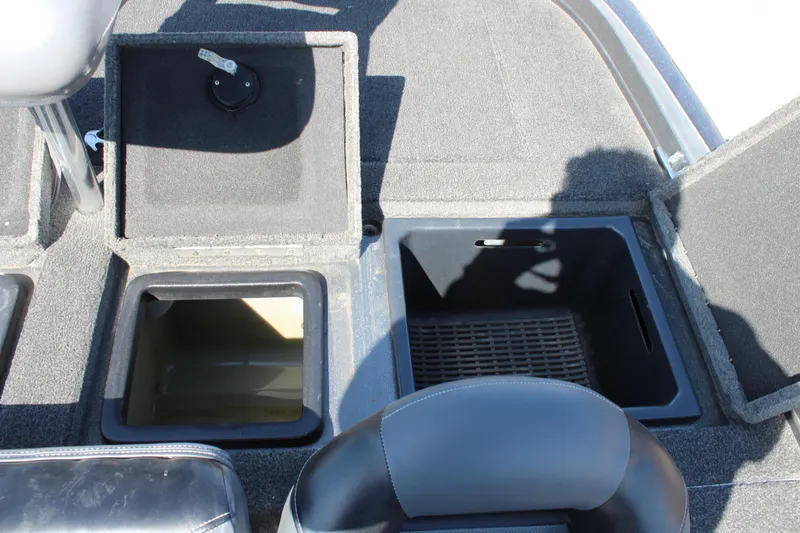 Slide: The Image of 2005 Nitro 901 CDX boat storage compartments with open lids and seating area. - 11
