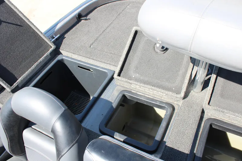 Slide: The Image of 2005 Nitro 901 CDX boat interior with open storage compartments and seating. - 12