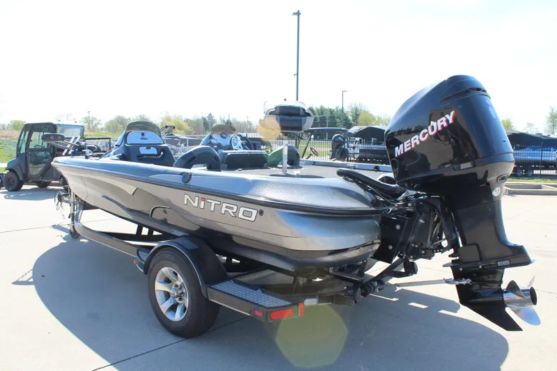 Slide: The Image of 2005 Nitro 901 CDX boat with Mercury engine on trailer, parked outdoors. - 6