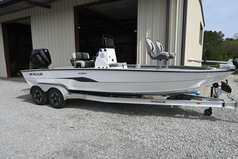 Slide: The Image of 2025 Vexus ACX2210 boat on trailer outside a garage. - 0