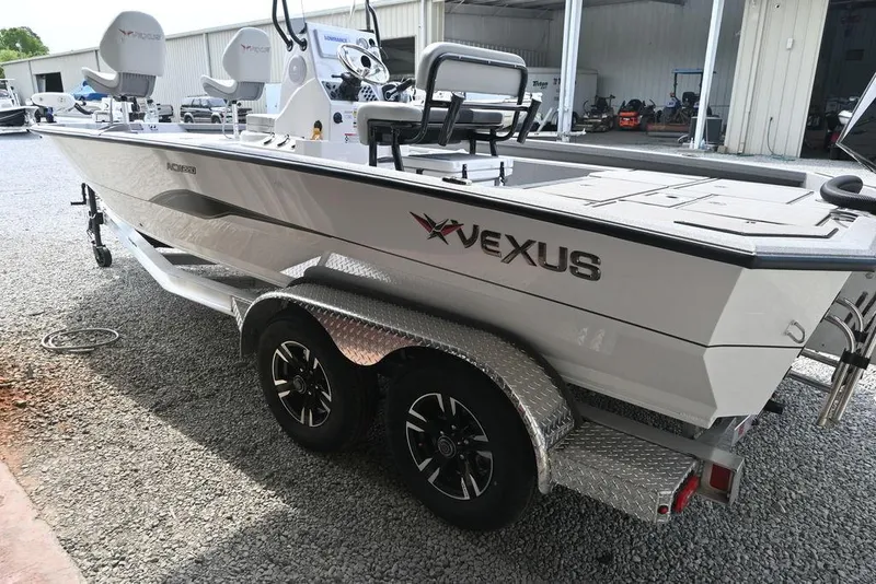 Slide: The Image of 2025 Vexus ACX2210 boat on trailer, parked outdoors near a building. - 1