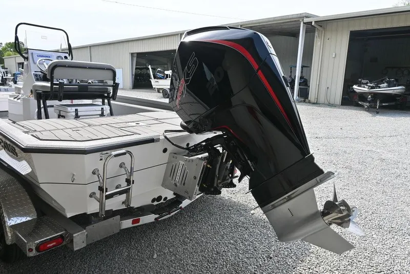 Slide: The Image of 2025 Vexus ACX2210 boat with powerful outboard motor in a storage facility. - 12