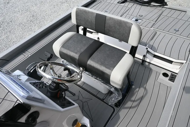 Slide: The Image of 2025 Vexus ACX2210 boat interior with dual-tone seating and steering console. - 7