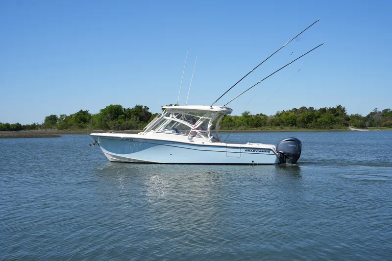Slide: The Image of 2022 Grady-White Freedom 285 boat on calm water with clear blue sky. - 1