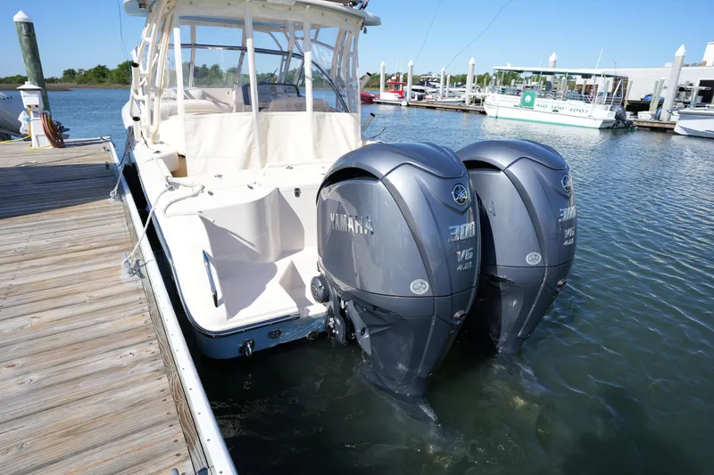 Slide: The Image of 2022 Grady-White Freedom 285 boat docked with twin Yamaha outboard engines. - 13