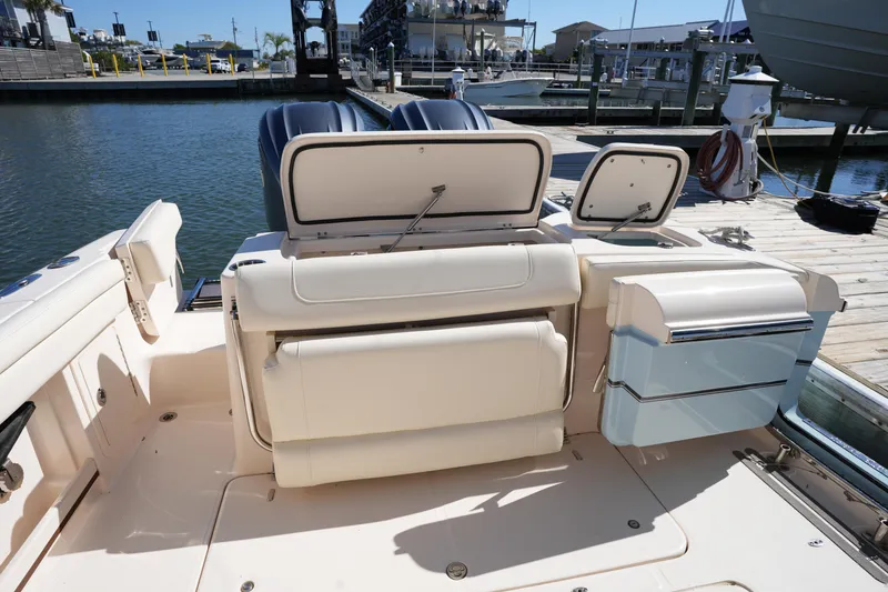 Slide: The Image of 2022 Grady-White Freedom 285 boat interior with seating and storage, docked at marina. - 15