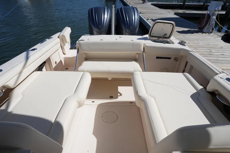 Slide: The Image of 2022 Grady-White Freedom 285 boat interior with spacious seating and twin engines. - 18