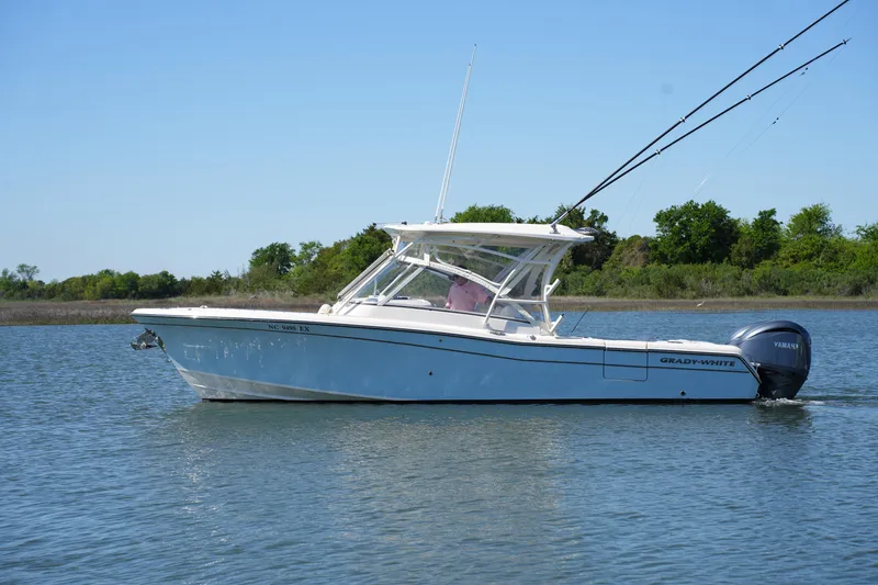 Slide: The Image of 2022 Grady-White Freedom 285 boat on calm water, side view. - 2