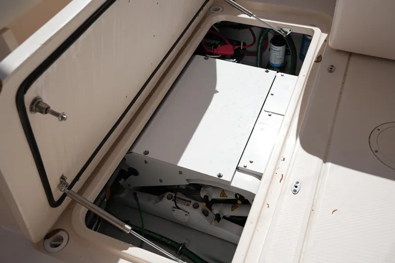 Slide: The Image of 2022 Grady-White Freedom 285 boat storage compartment with mechanical components visible. - 20