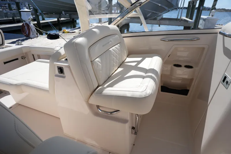 Slide: The Image of 2022 Grady-White Freedom 285 boat interior with white seating and cup holders. - 22