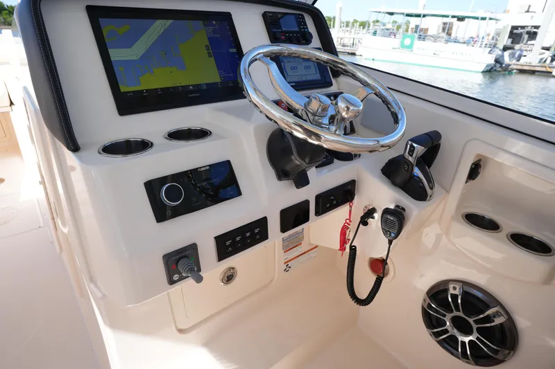 Slide: The Image of 2022 Grady-White Freedom 285 helm with navigation display and controls. - 28