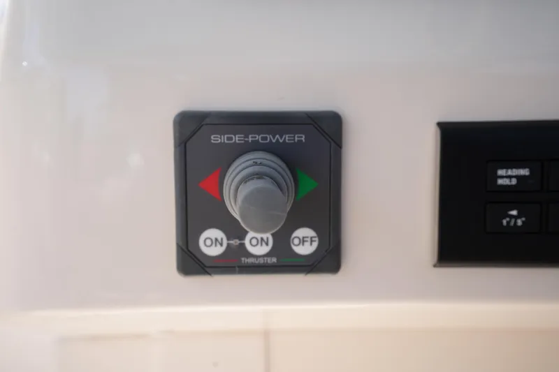 Slide: The Image of Control panel of 2022 Grady-White Freedom 285 boat, featuring Side-Power thruster switch. - 29