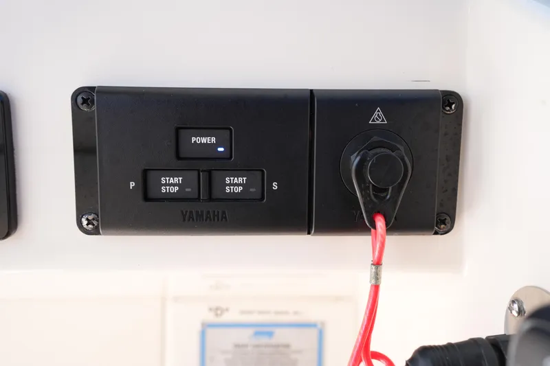 Slide: The Image of Control panel of a 2022 Grady-White Freedom 285 boat with Yamaha start/stop buttons. - 31