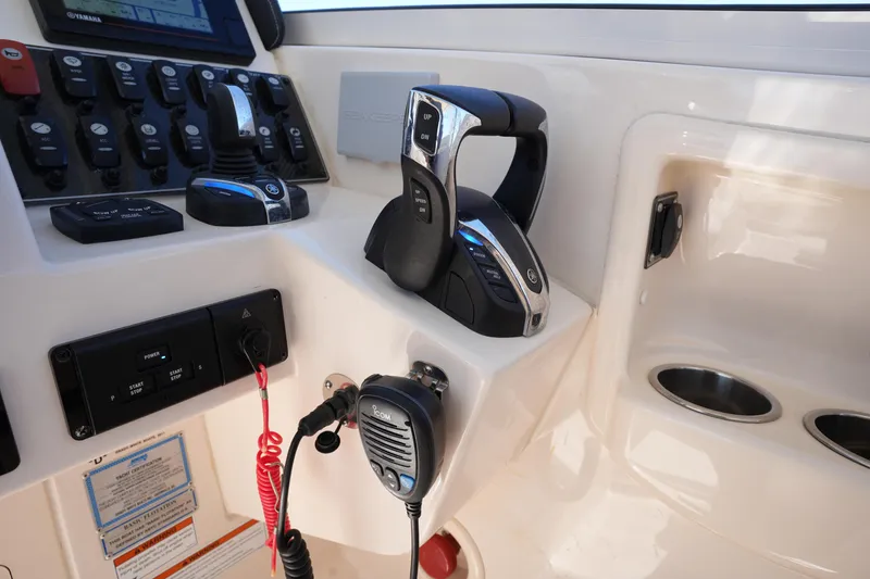 Slide: The Image of Control panel of 2022 Grady-White Freedom 285 boat with radio and throttle. - 32