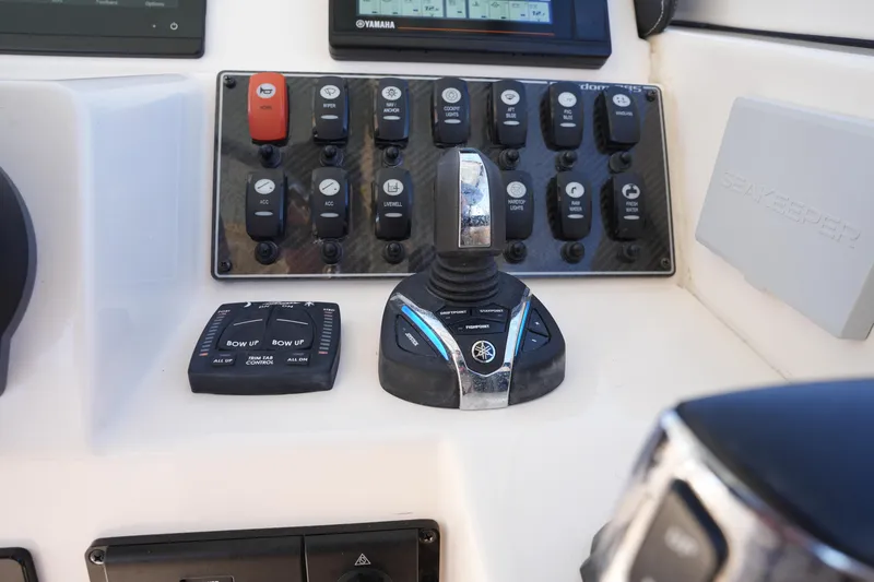 Slide: The Image of Control panel of 2022 Grady-White Freedom 285 boat with joystick and switches. - 33