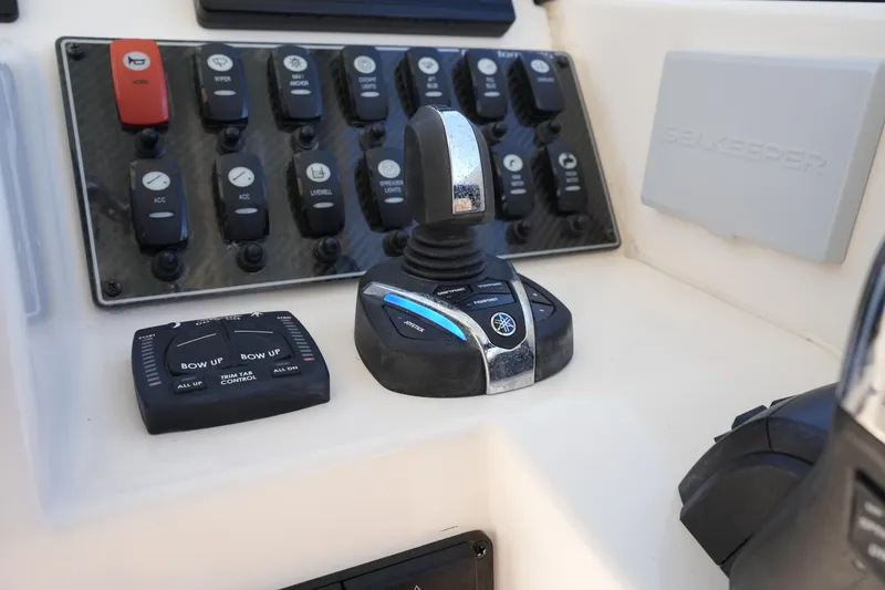 Slide: The Image of Control panel of 2022 Grady-White Freedom 285 boat with joystick and switches. - 35
