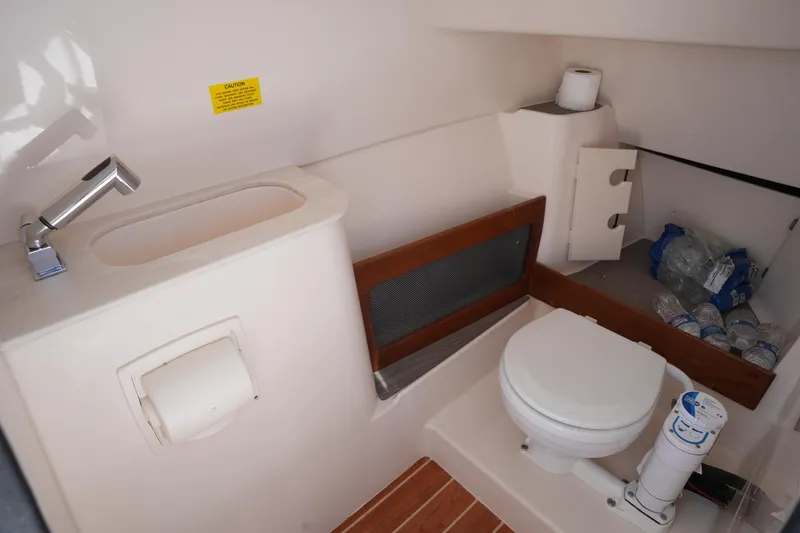 Slide: The Image of 2022 Grady-White Freedom 285 boat bathroom with sink, toilet, and storage space. - 41